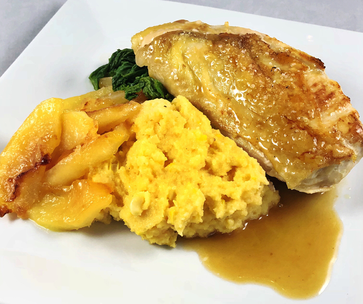 Pan Seared Chicken with Cider Lemon Sauce, Caramelized Apples, Cheddar Polenta with Fresh Corn, and Sautéed Mustard Greens